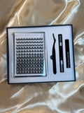 Alter Ego Cluster Kit open box showing jumbo tray of DIY cluster lashes, bond, seal, tweezers and remover on white satin fabric