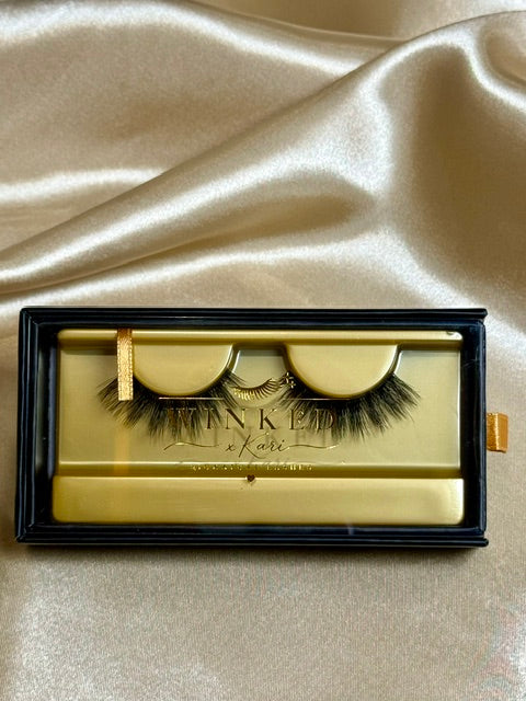 Cashmere strip lashes in black and gold Winked x Kari box on satin fabric