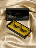 Envy strip lashes in open black and gold Winked x Kari box on champagne satin fabric