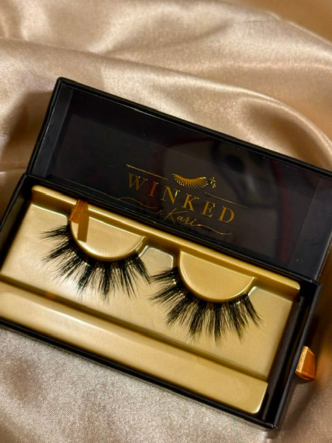 Envy strip lashes close up in gold Winked x Kari tray showing full dramatic volume