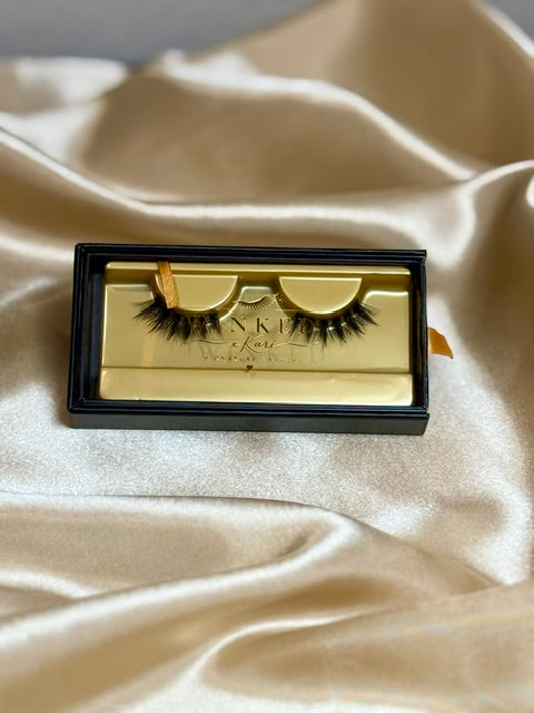 Kiss Me strip lashes in gold Winked x Kari tray on champagne satin fabric