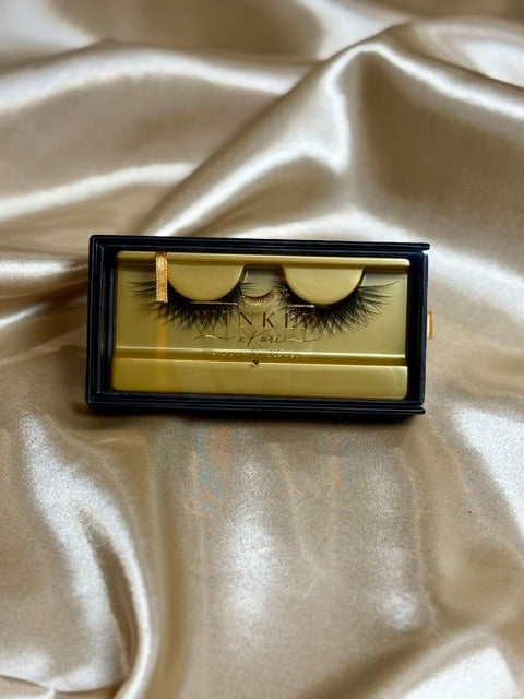 Vixen strip lashes in gold Winked x Kari tray with black frame on champagne satin fabric